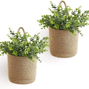 Set of two jute hanging planter baskets with greenery, perfect for walls indoors or on patios.