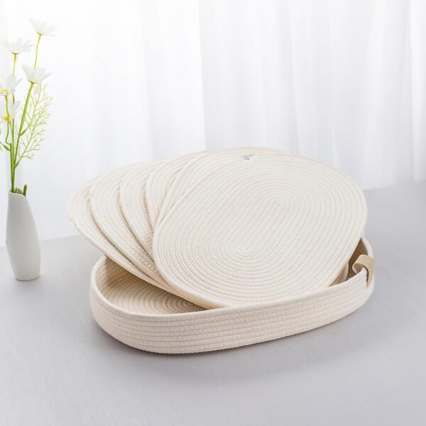 Matino Oval Placemats arranged on a table with a vase, showcasing their elegant design and functionality