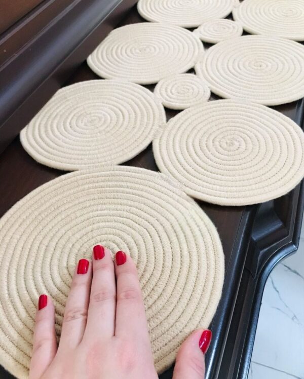 Handcrafted cotton rope table runner with circular patterns, styled on a dining table for rustic decor.