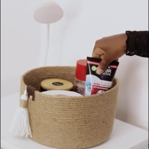 ute storage basket, eco-friendly jute basket, handcrafted jute organizer, bathroom storage basket, natural jute decor, tassel jute basket, rustic storage bin, compact jute basket, home organization jute basket, small storage basket for toiletries