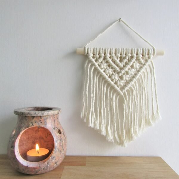 Handmade small macrame wall hanging with V-shaped tassels and wooden rod, perfect for boho home decor.”
