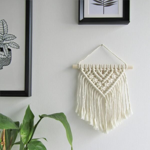 Handmade small macrame wall hanging with V-shaped tassels and wooden rod, perfect for boho home decor.”